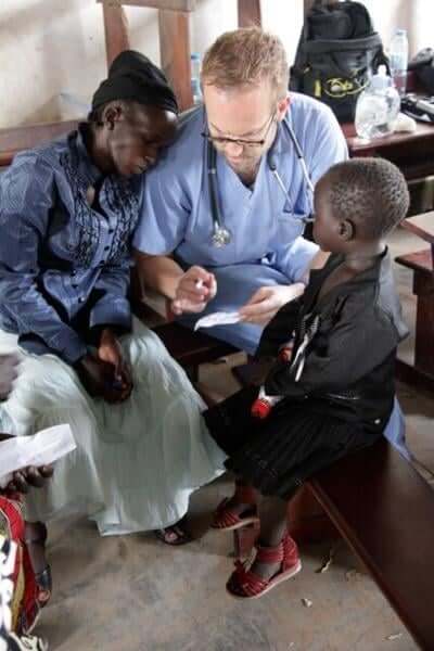 A Healing Kadi doctor treating a woman and her son
