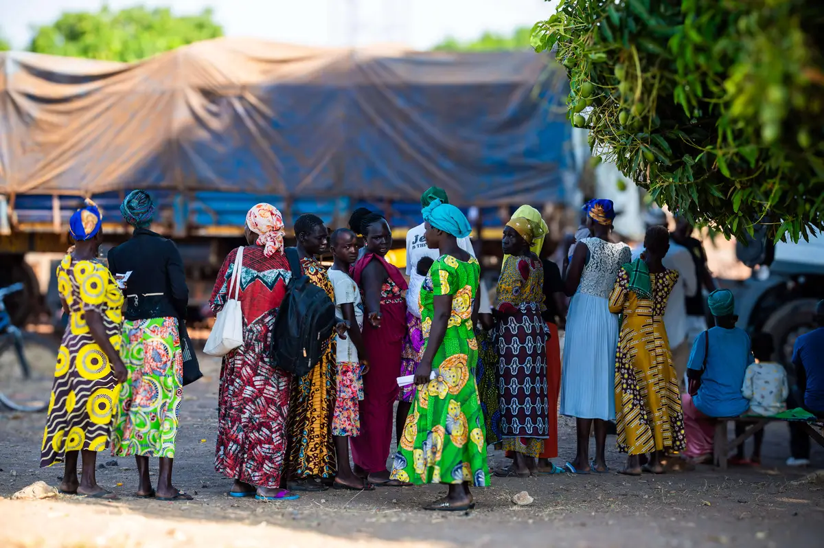 A Group of women posing for the camera and waiting for aid.