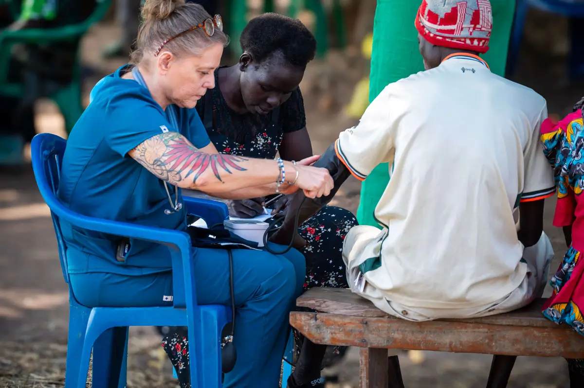A doctor treating the wounds of a Sudanese man.
