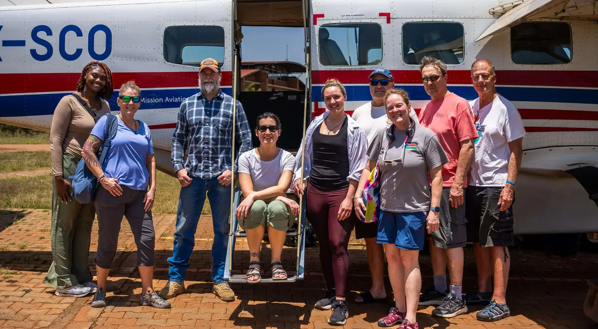 A group of Healing Kadi members proudly posing and smiling.
